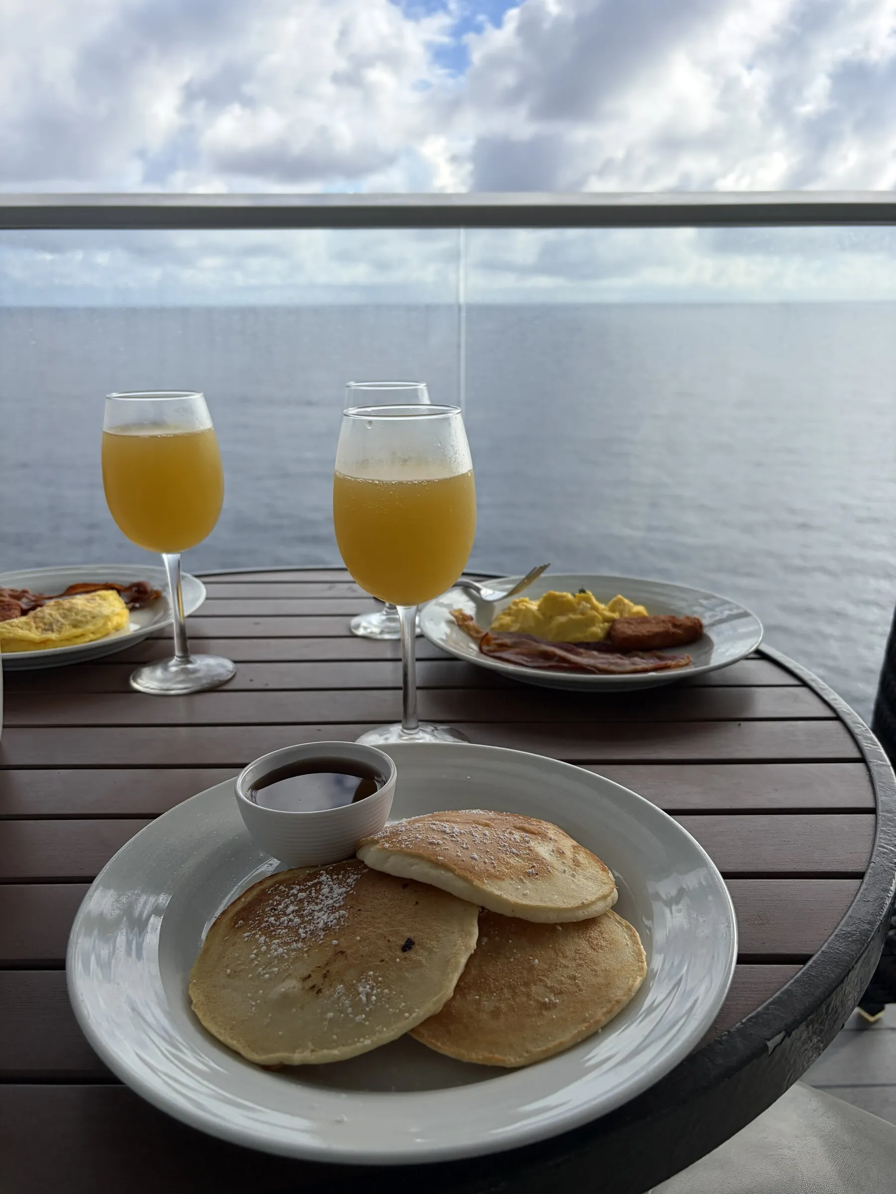 Breakfast and mimosas on a cruise ship balcony overlooking the ocean