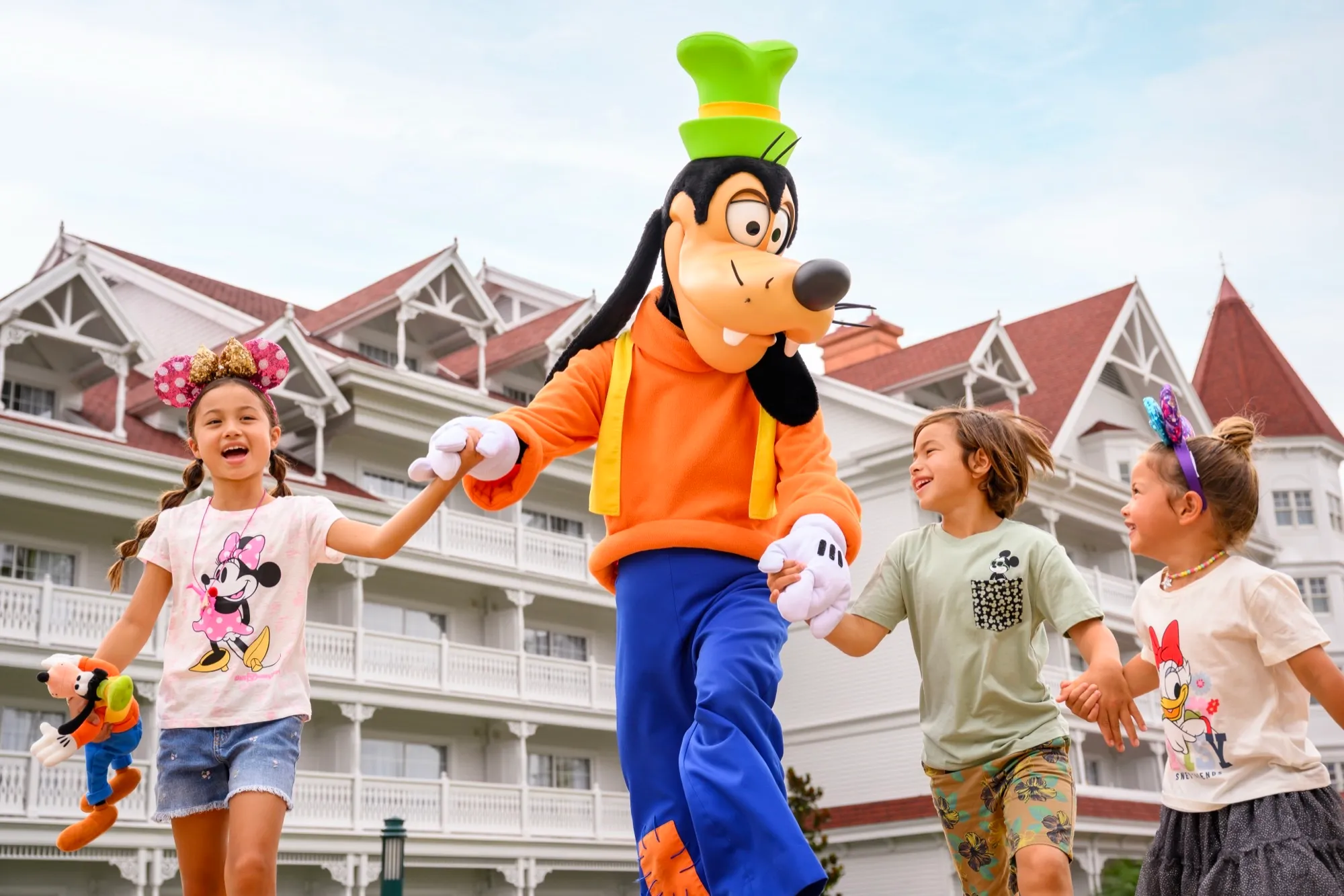 Goofy character greeting children outside a Disney resort hotel
