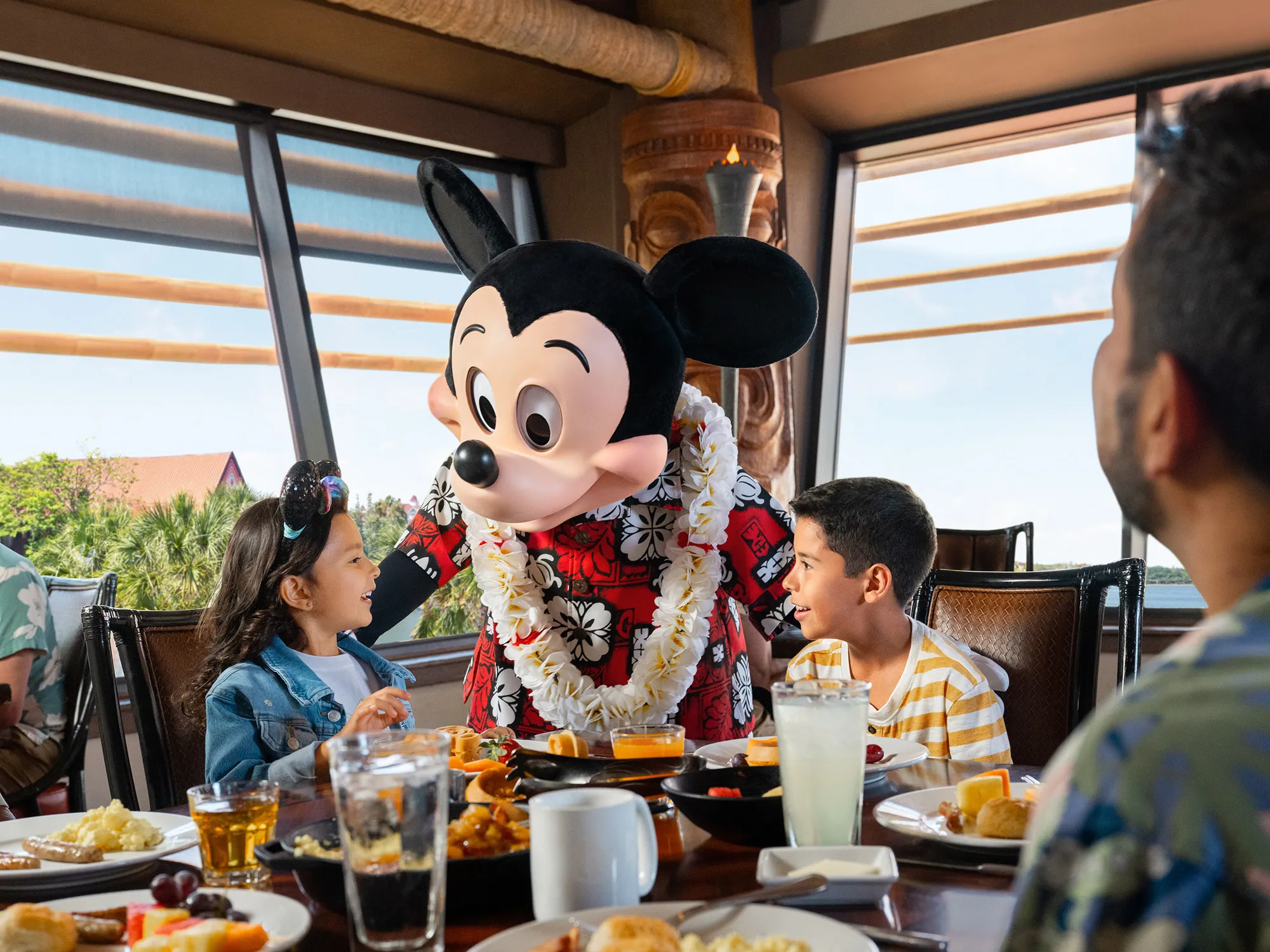 Family dining at a Disney character meal with Mickey Mouse